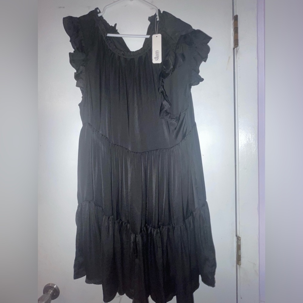 short black slinky dress, with frilly capped sleeves.
